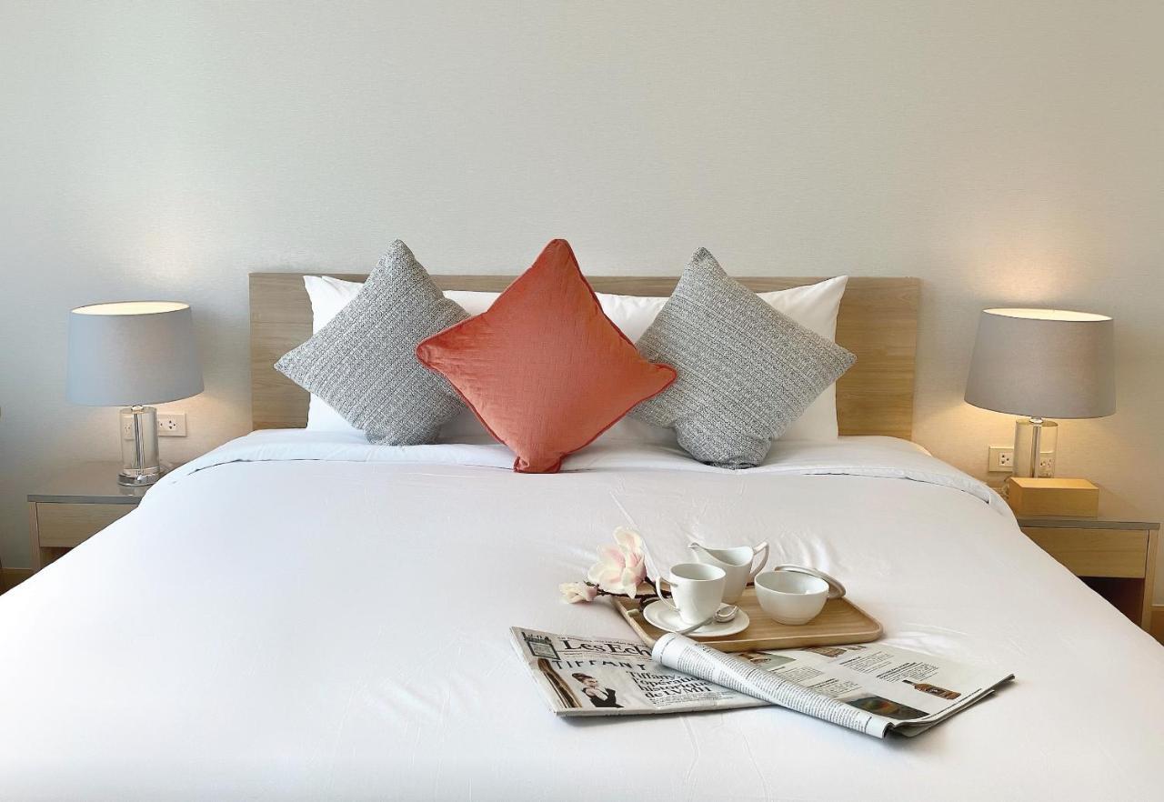 Oakwood Suites Bangkok Kültér fotó A bed with cushions